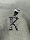 Sterling silver initial K pendant with a row of channel-set cubic zirconia, on pale grey felt.