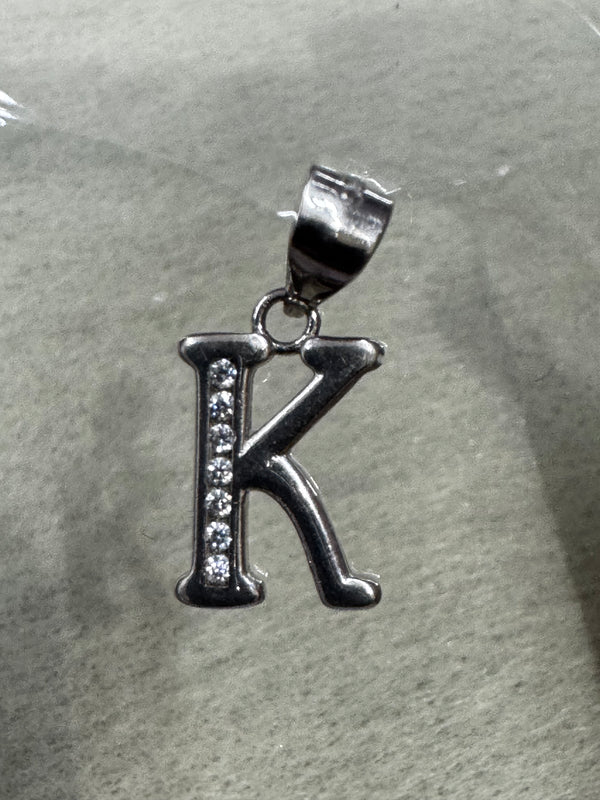 Sterling silver initial K pendant with a row of channel-set cubic zirconia, on pale grey felt.