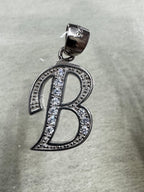 Close view of the sterling silver initial B pendant showing the row of larger cubic zirconia across the centre stroke.