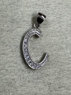 Close view of the sterling silver initial C pendant showing the beaded edging either side of the cubic zirconia.