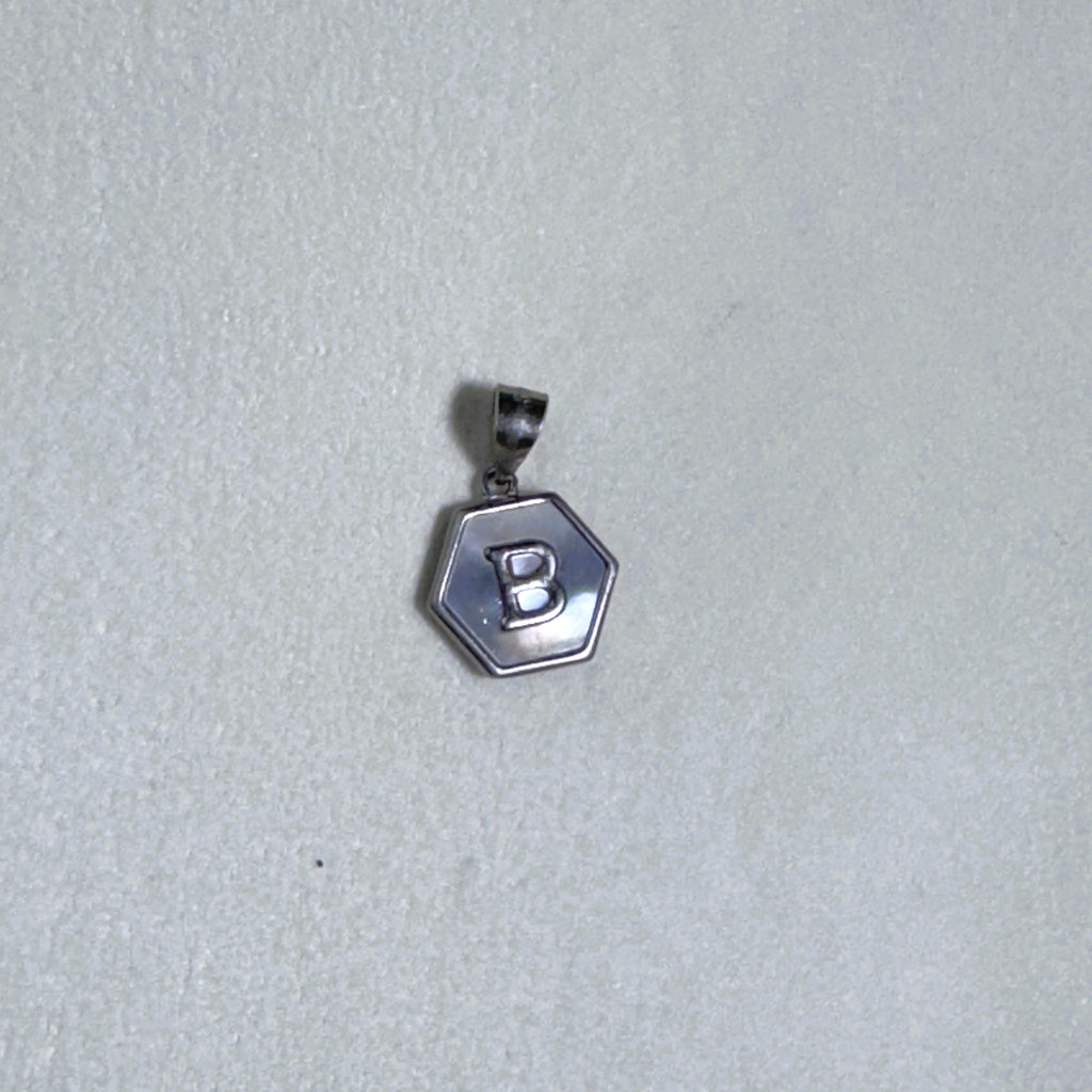 Sterling silver hexagon initial pendant with a mother of pearl face and the letter B.