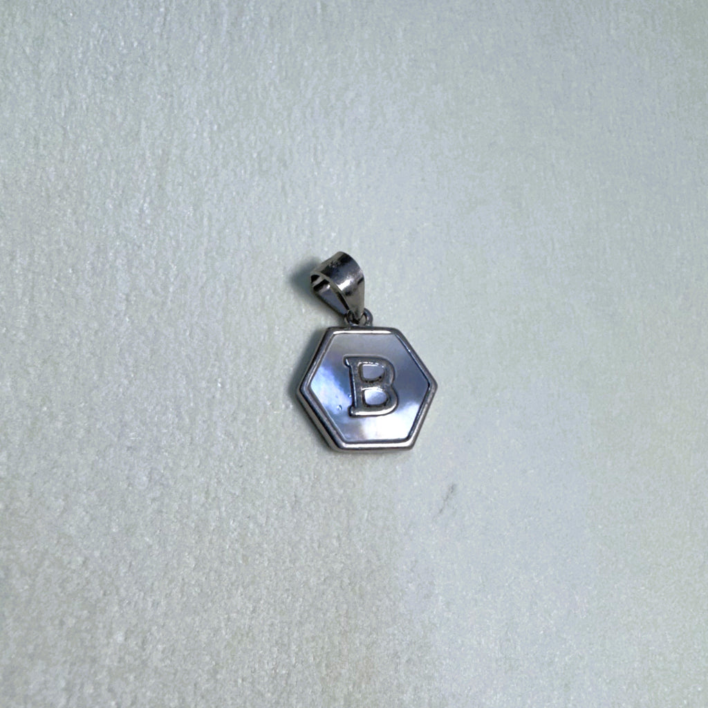 The letter B hexagon pendant seen from a slight angle.