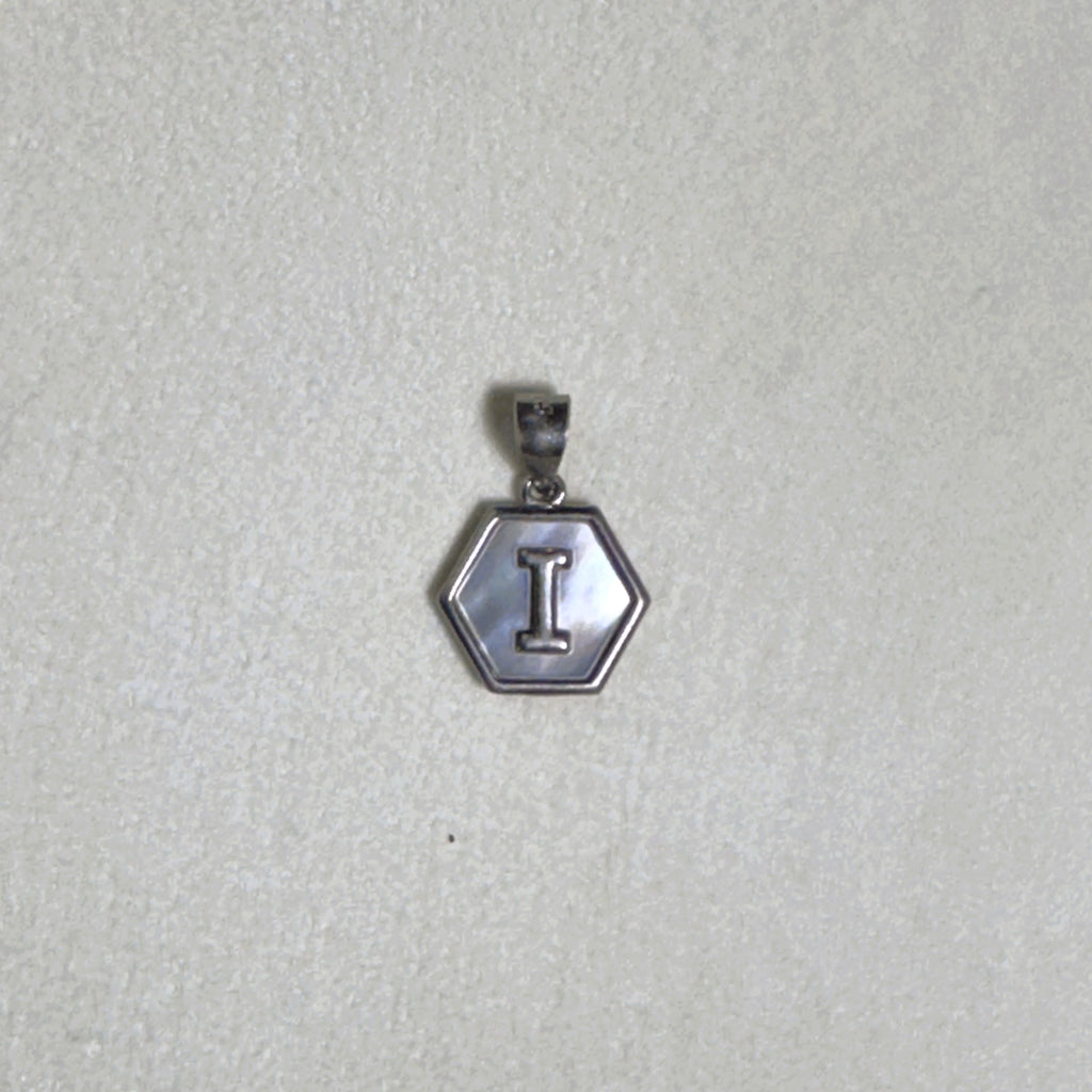The letter I pendant seen from a slight angle.