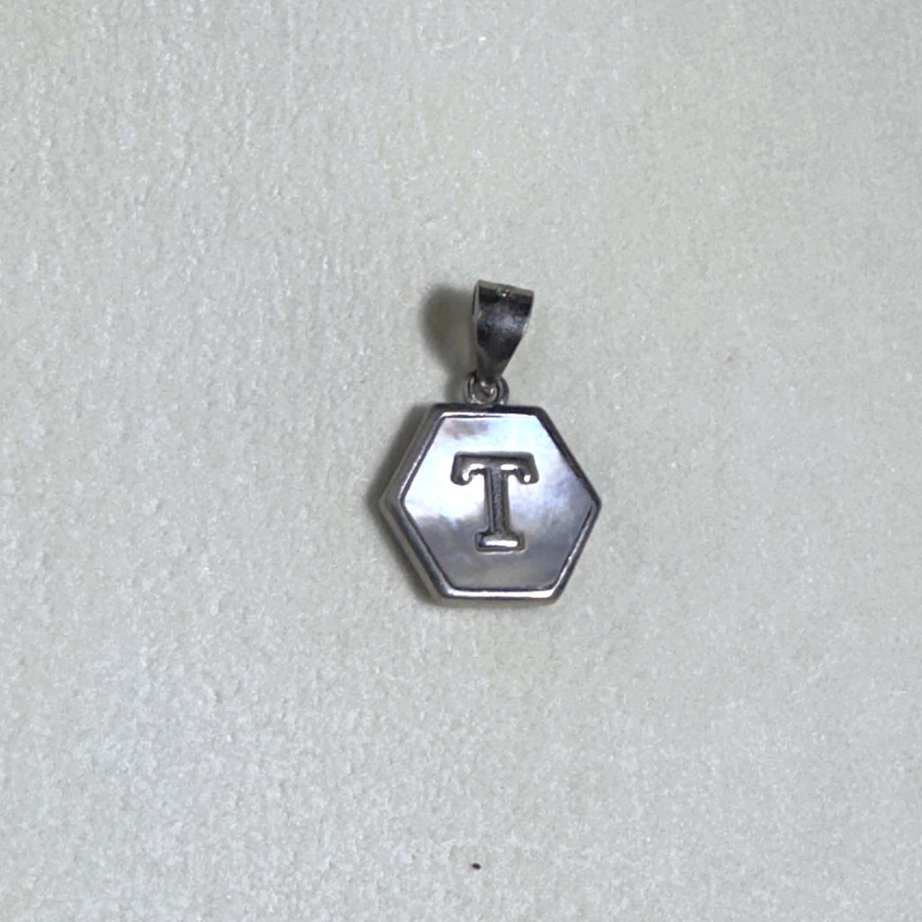 The letter T pendant seen from a slight angle.