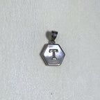 The letter T pendant seen from a slight angle.