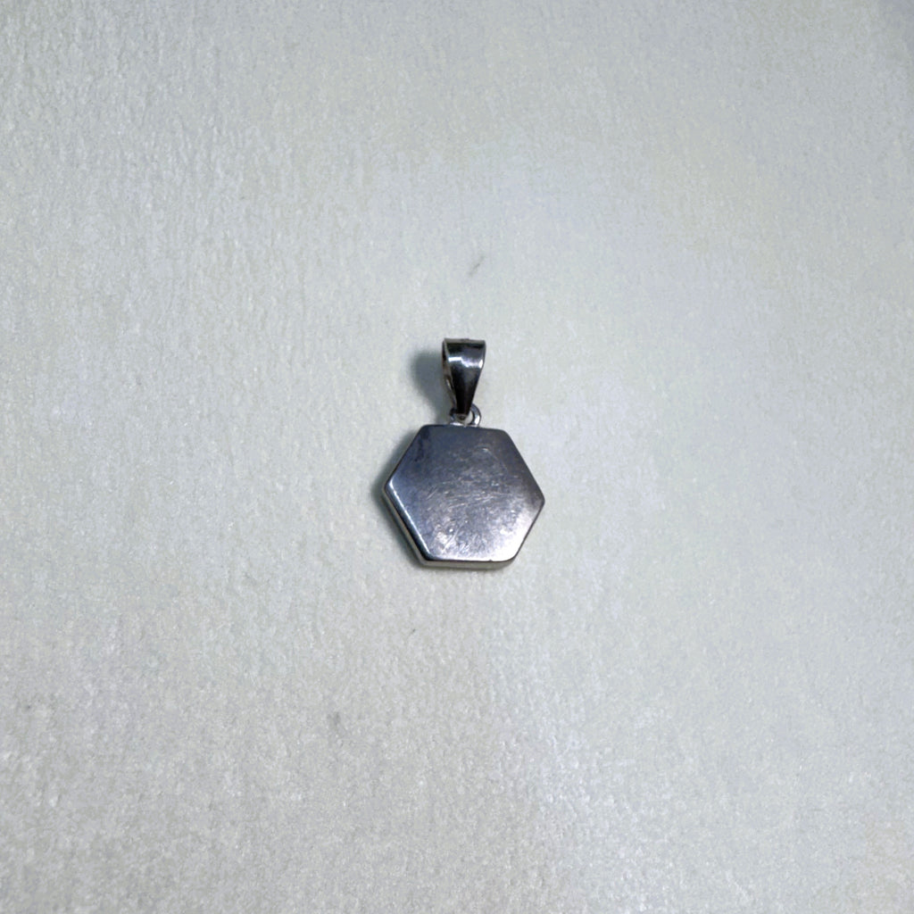 The plain polished silver back of the hexagon initial pendant.