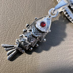 Close view of the fish head, the red glass eye and the scale pattern.