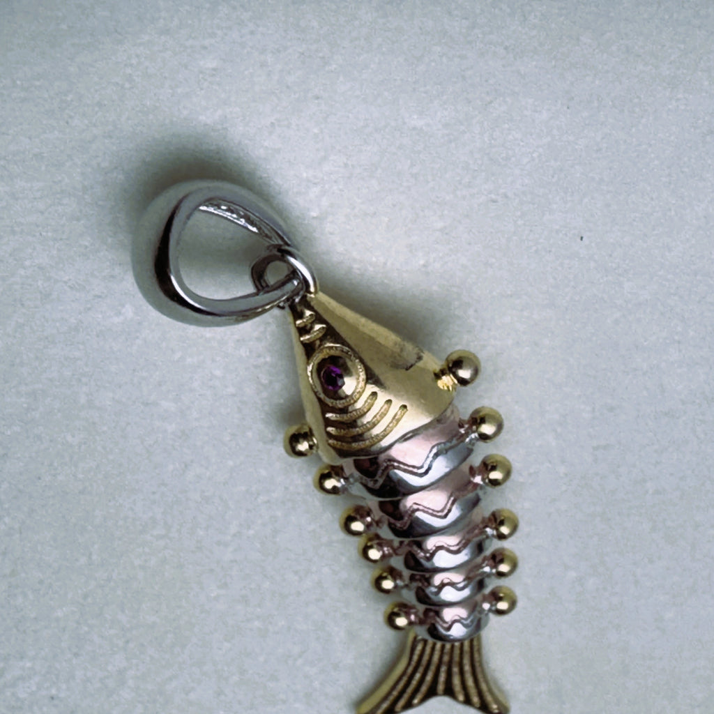 The tri-tone fish pendant with its silver bail, seen from above.