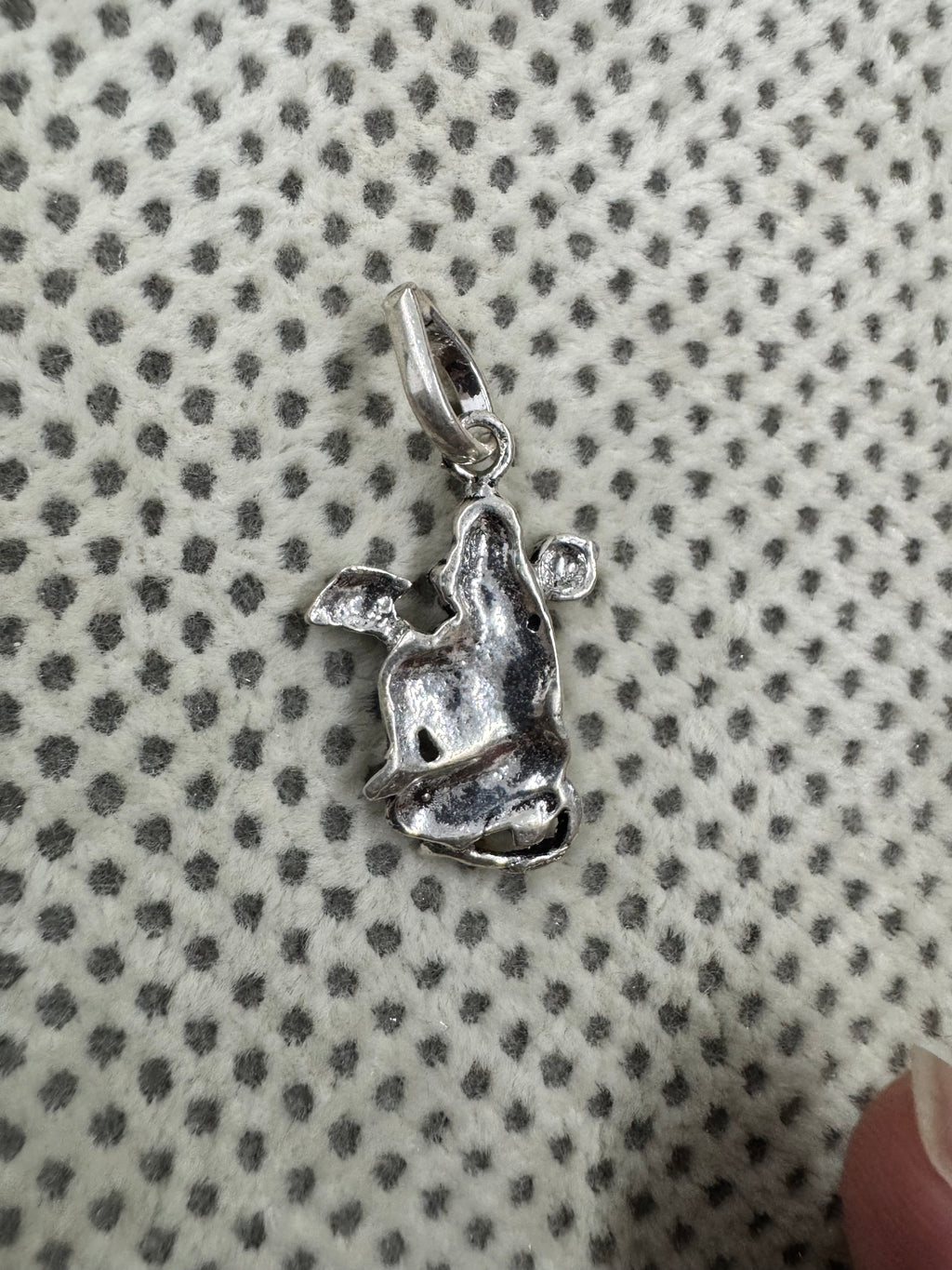 Reverse of the sterling silver Hanuman pendant, showing the hollowed back and the curved tube bail.