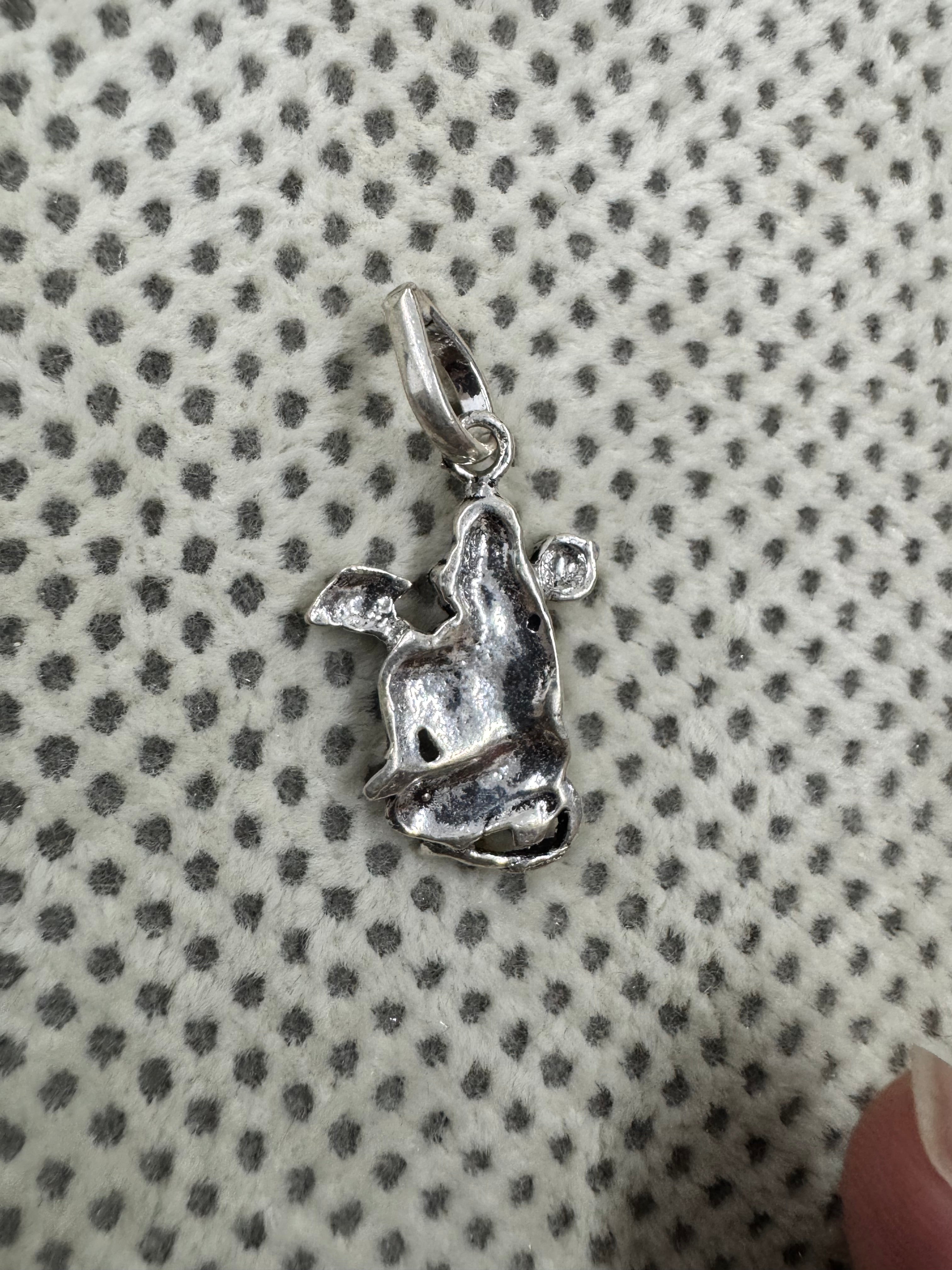 Reverse of the sterling silver Hanuman pendant, showing the hollowed back and the curved tube bail.