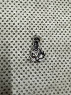 Reverse of the sterling silver pendant, showing the smooth hollow back behind the cast figure.