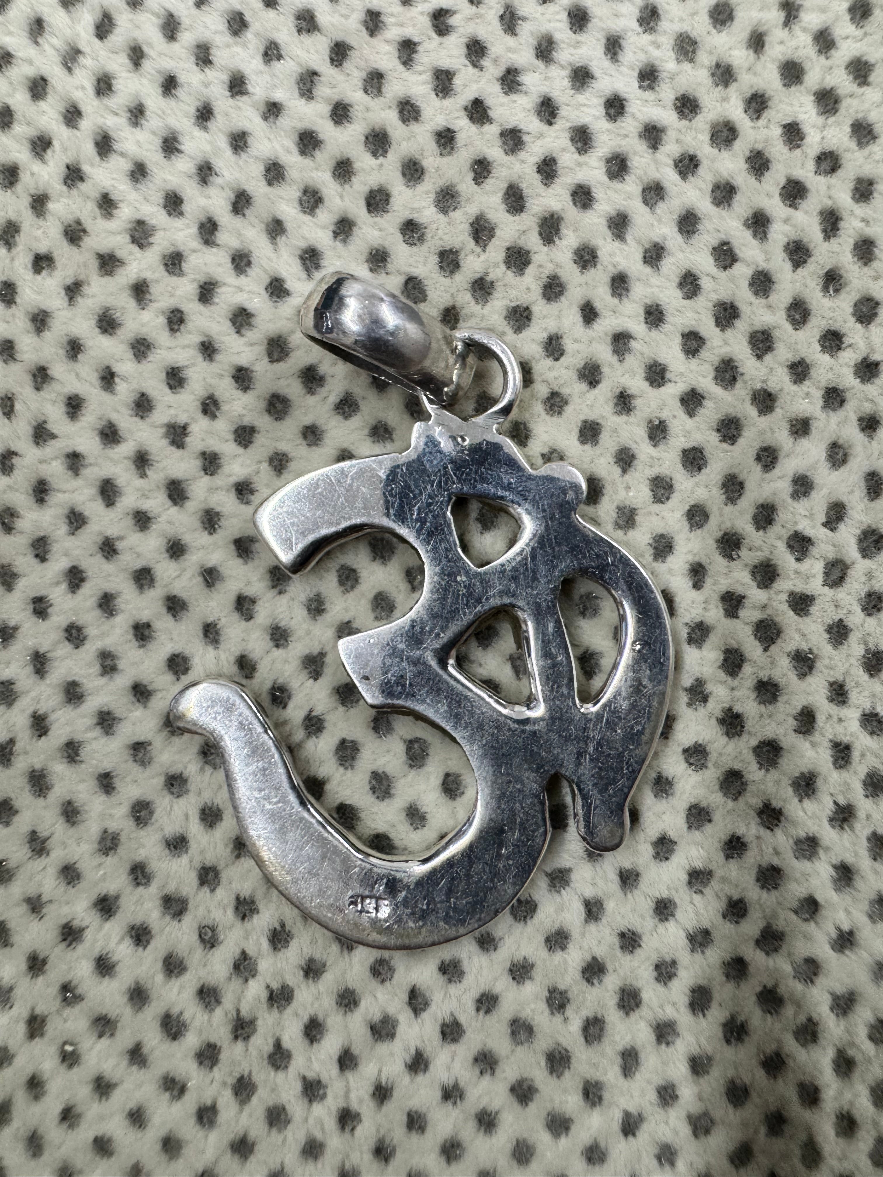 Reverse of the sterling silver Om pendant, showing the flat back and the 925 purity stamp.