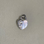 Sterling silver heart padlock charm, half engraved with the word LOVE and half white mother of pearl.