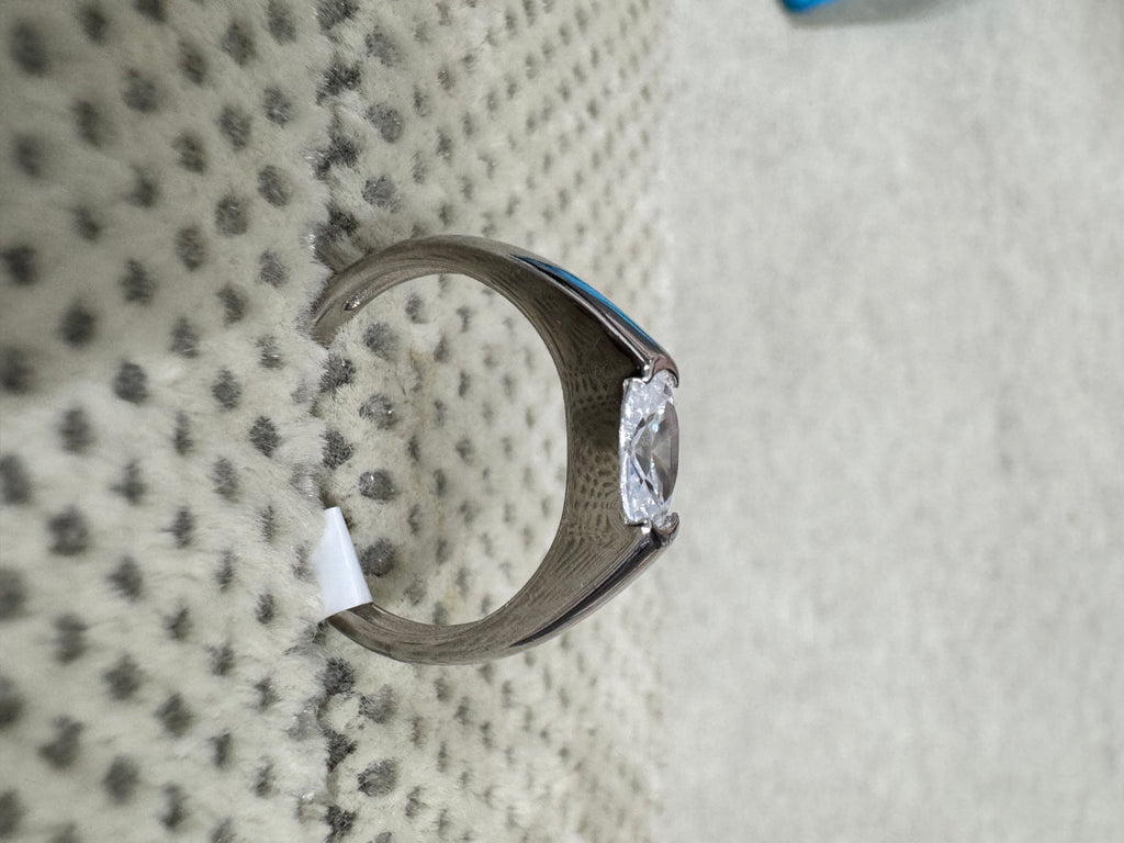 Side profile of the sterling silver cubic zirconia ring, showing the tapering shank and the open girdle of the stone.