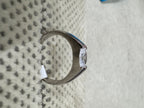 Side profile of the sterling silver cubic zirconia ring, showing the tapering shank and the open girdle of the stone.