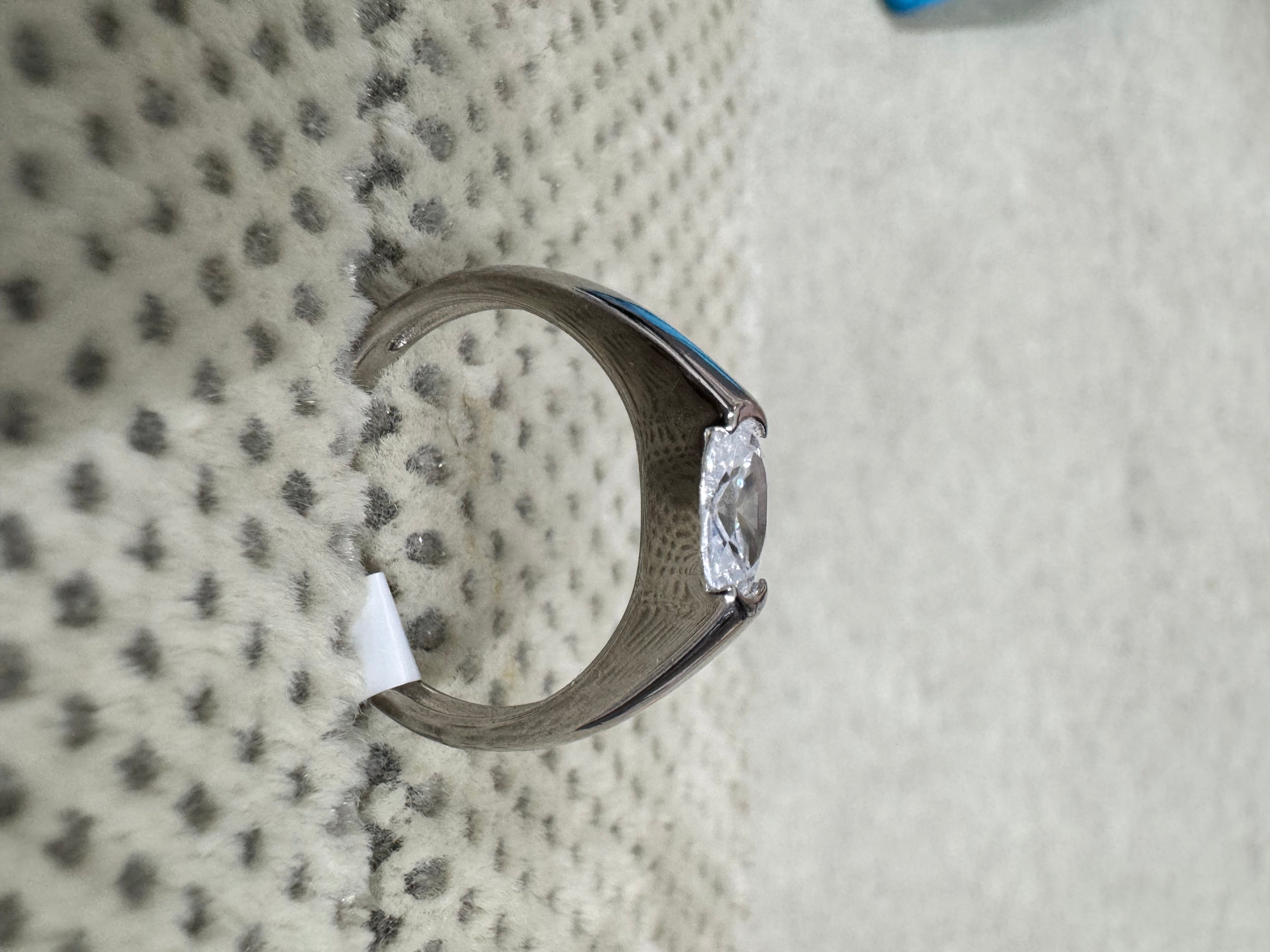 Side profile of the sterling silver cubic zirconia ring, showing the tapering shank and the open girdle of the stone.