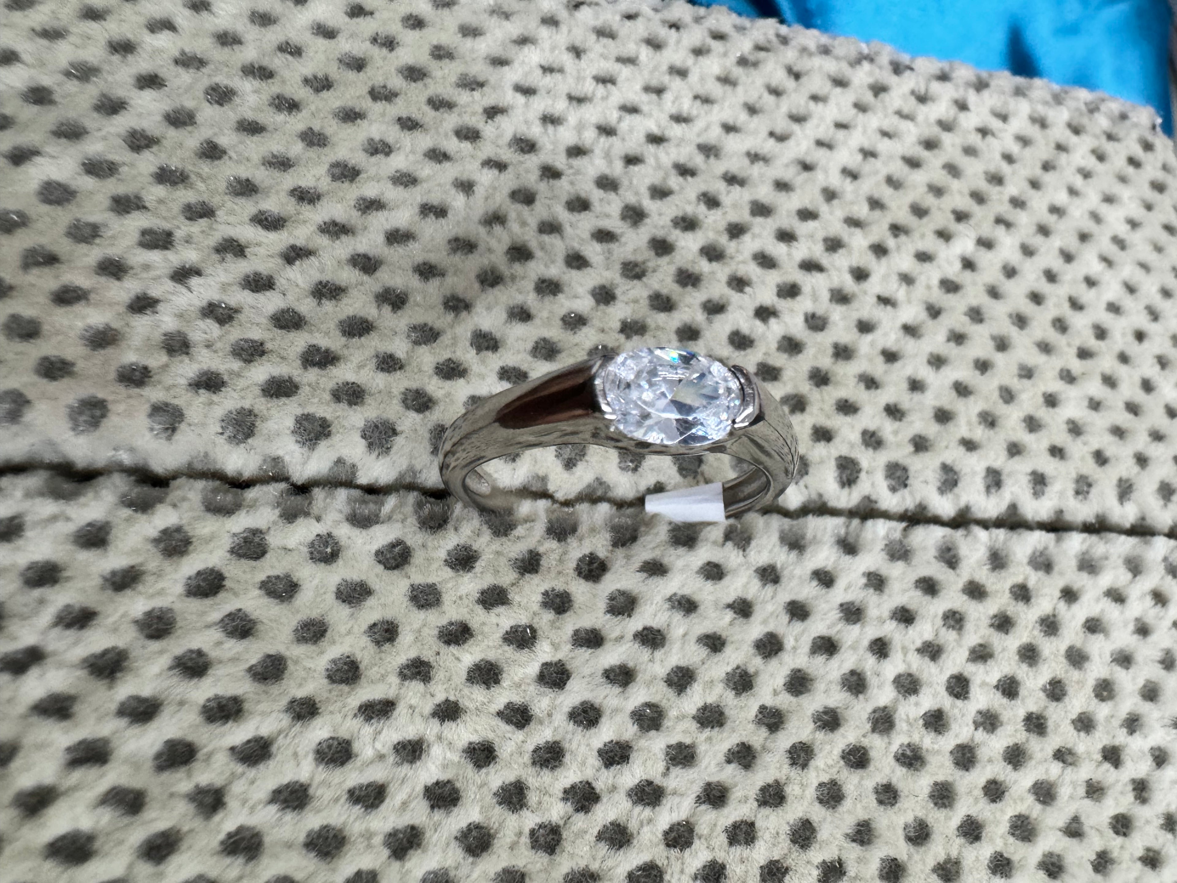 Top view of the sterling silver solitaire ring, with the oval cubic zirconia set across the finger.