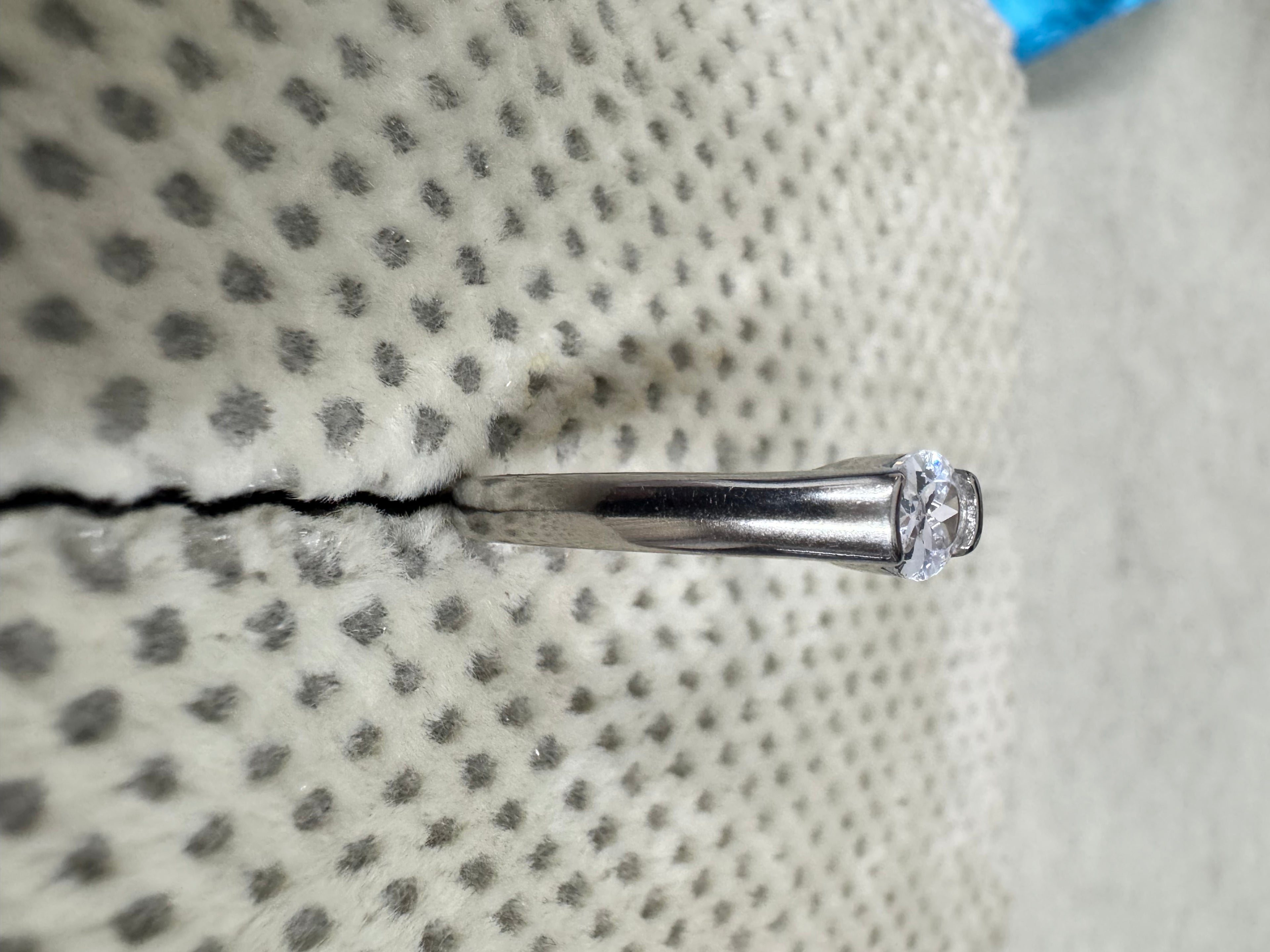 Sterling silver cubic zirconia ring viewed along the shank, the stone raised at the end of the tapering band.