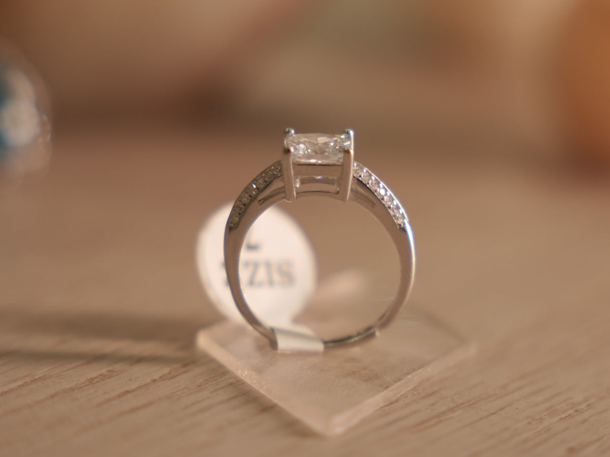 Sterling silver solitaire ring with a square cushion cut American Diamond in a four prong basket.
