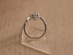 The sky blue stone bypass ring standing on its band.