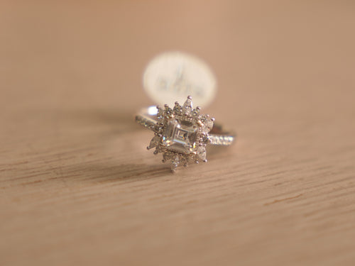 Sterling silver ring with an asscher cut American Diamond inside a starburst halo of marquise stones.