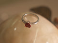 Sterling silver ring with a deep red heart shaped American Diamond on a plain polished band.
