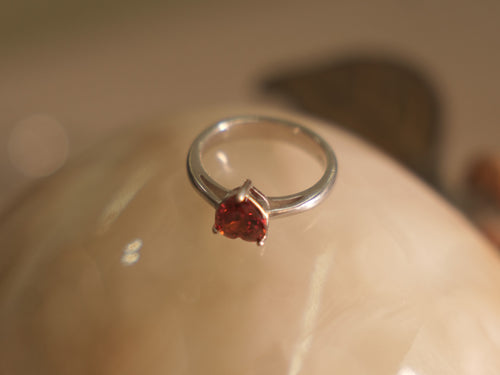 Sterling silver ring with a deep red heart shaped American Diamond on a plain polished band.