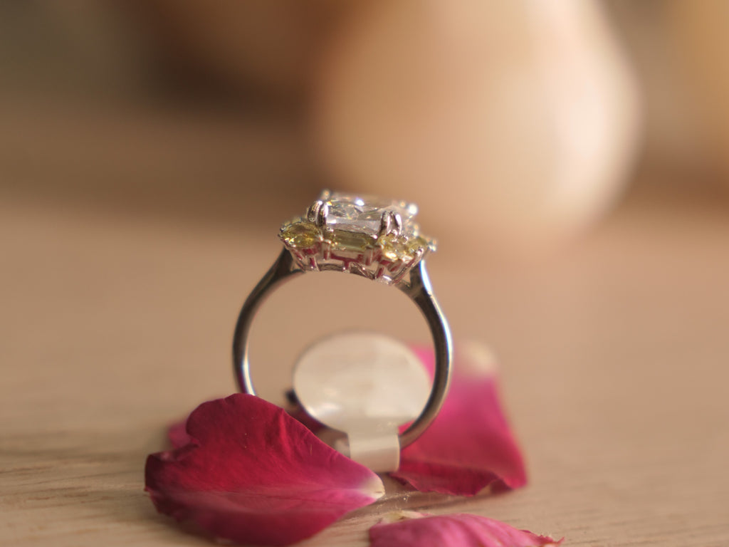 The crystal cocktail ring resting on a pale wooden surface.
