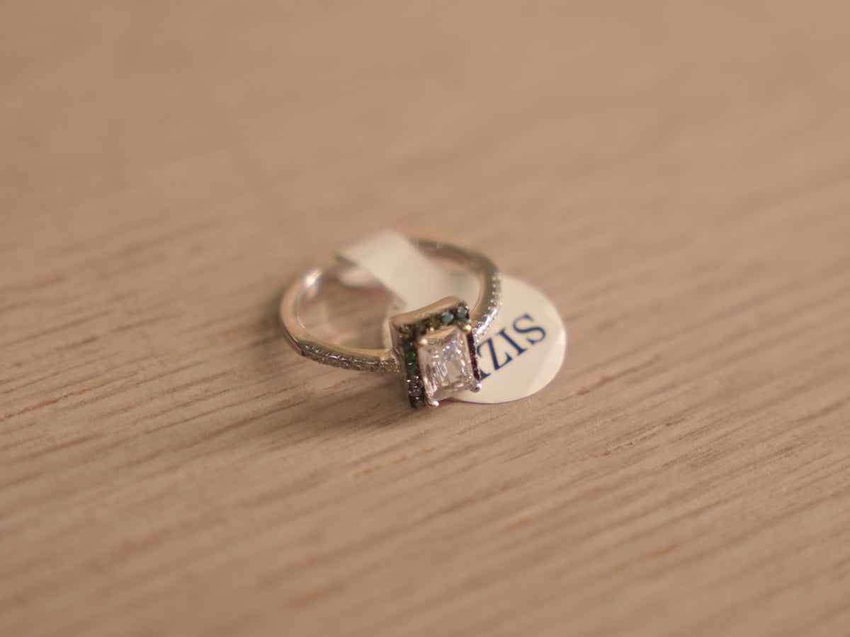 Sterling silver ring with an emerald cut American Diamond in a slim frame edged with tiny coloured accents.