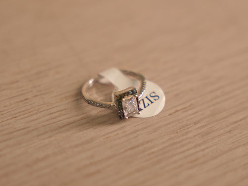 Sterling silver ring with an emerald cut American Diamond in a slim frame edged with tiny coloured accents.