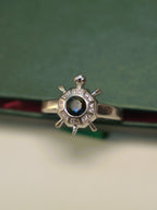 Top view of the octagon tortoise ring, showing the stone set panels around the blue centre.