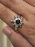 The octagon tortoise ring worn on a hand, showing its scale on the finger.