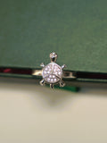 Top view of the small tortoise ring, showing the three pave set sections of the shell.