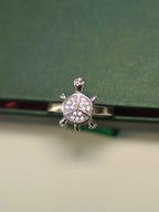 Top view of the small tortoise ring, showing the three pave set sections of the shell.