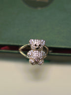 Front view of the teddy bear ring, showing the black eyes and the pink heart stone.