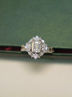 Top view of the emerald cut American Diamond ring, showing the full halo.