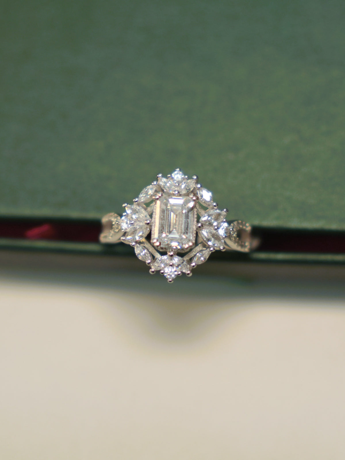 Top view of the emerald cut American Diamond ring, showing the full halo.