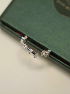 Close view of the prong set baguette and square stones on the open band ring.