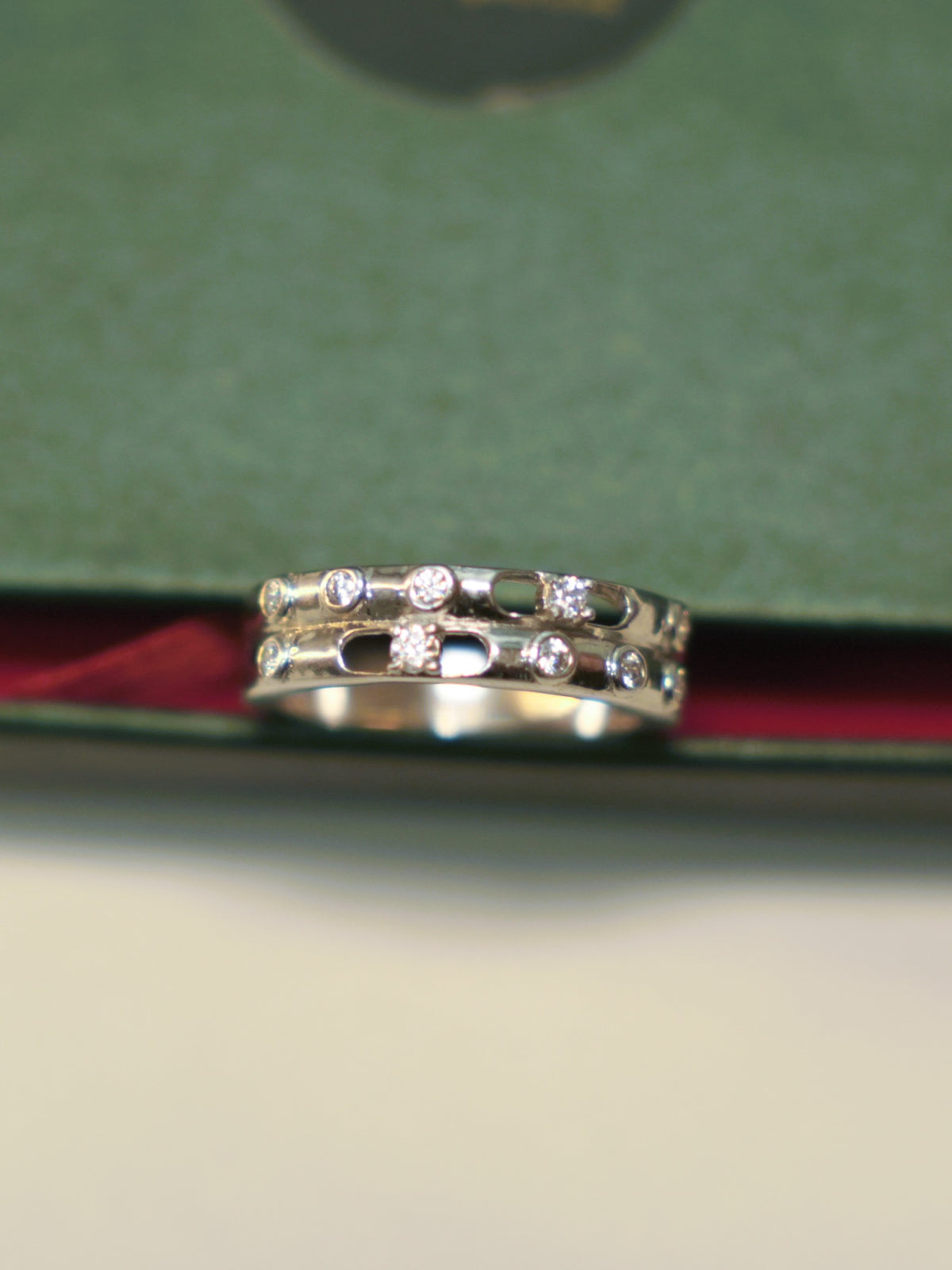 Sterling silver double row band ring with bezel set American Diamonds and oval cut-outs.