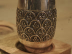 Top angle over the pair of silver drinking glasses, showing the bright plain rims.